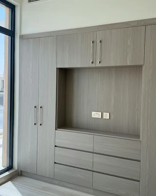 Built-in wardrobe and dresser in a gray wood finish