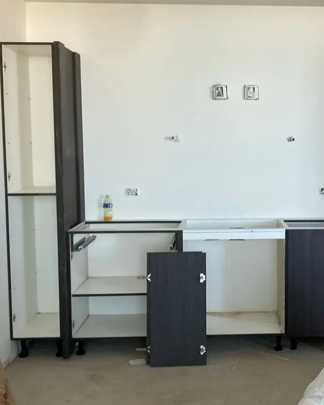 Cabinet boxes being installed in an empty room