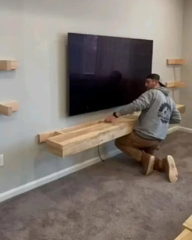 Installing a floating wood shelf under a wall-mounted TV