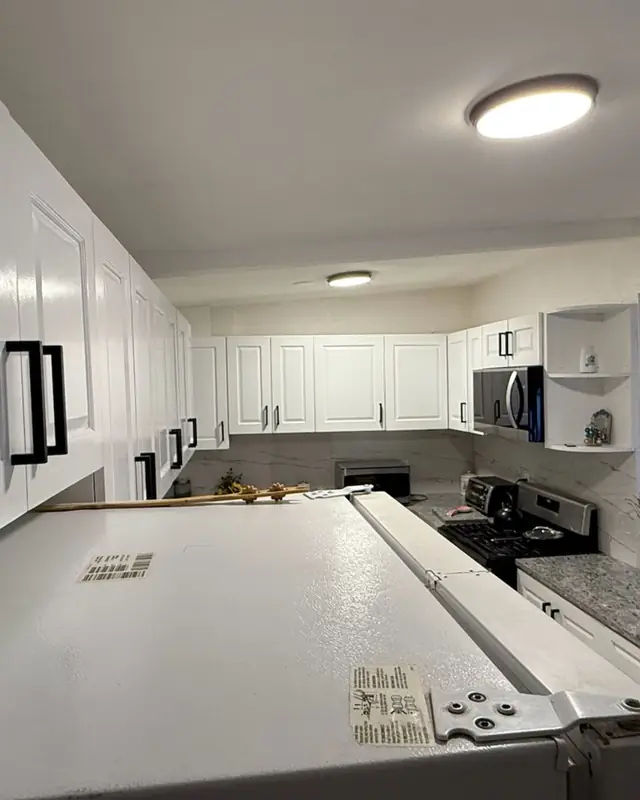 White kitchen cabinets with stainless steel appliances