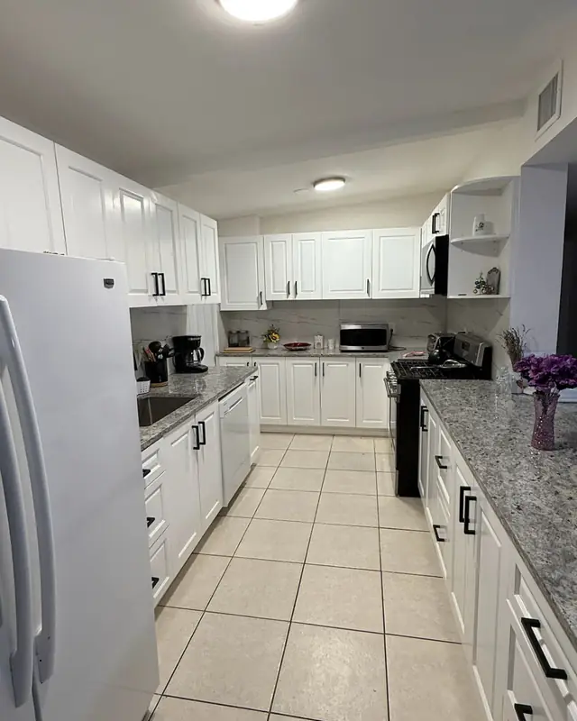 White kitchen cabinets with granite countertops