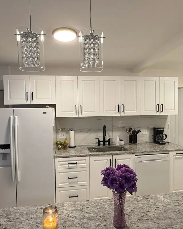White kitchen with pendant lights and an island