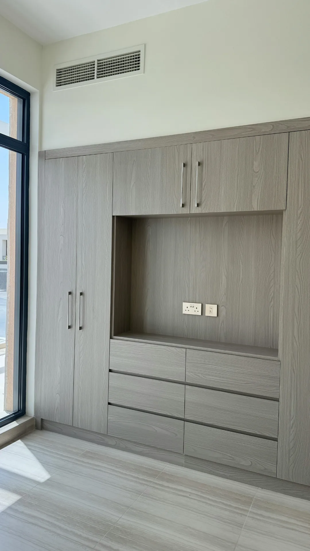 Built-in wardrobe and dresser in a gray wood finish