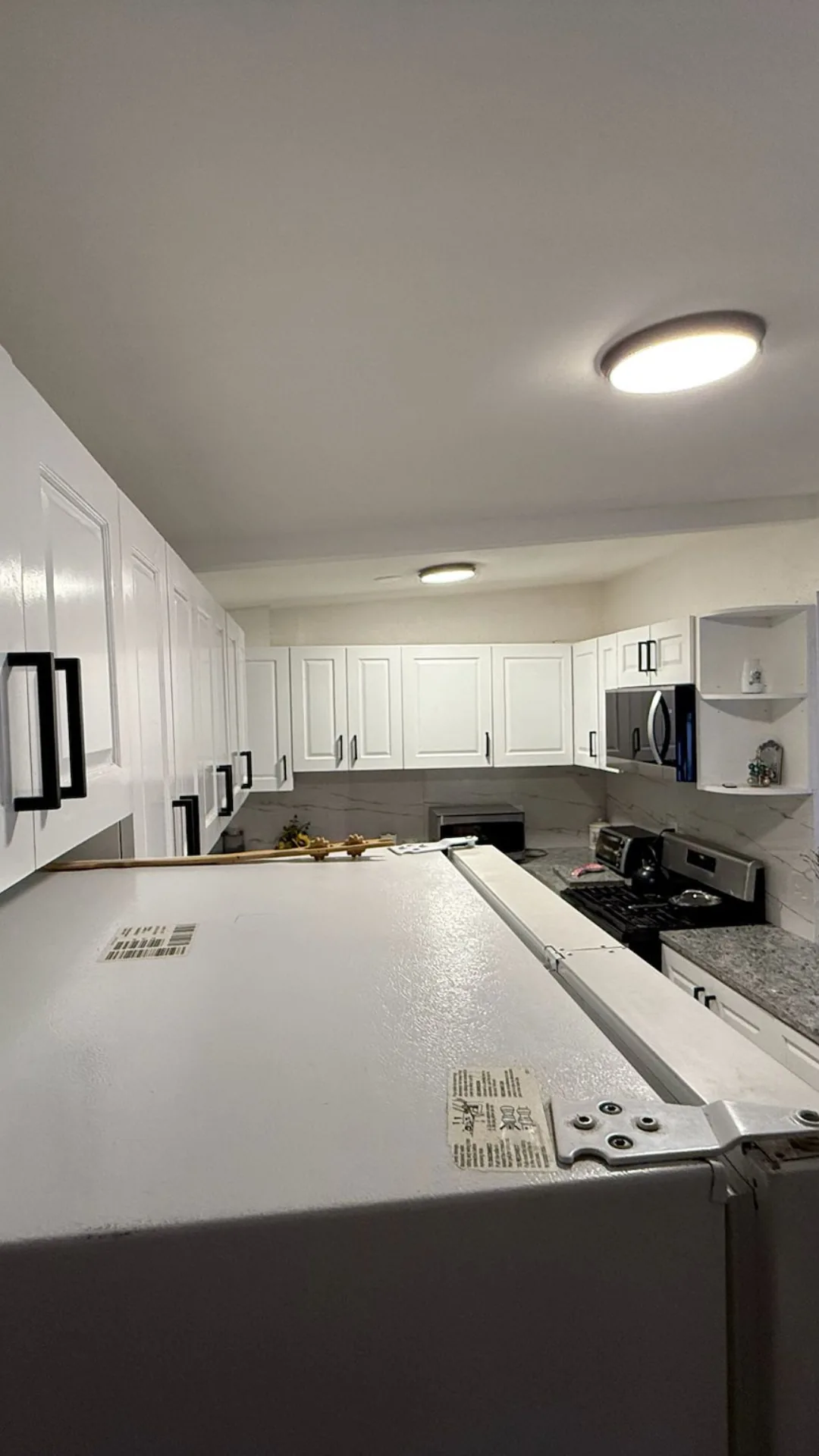 White kitchen cabinets with stainless steel appliances