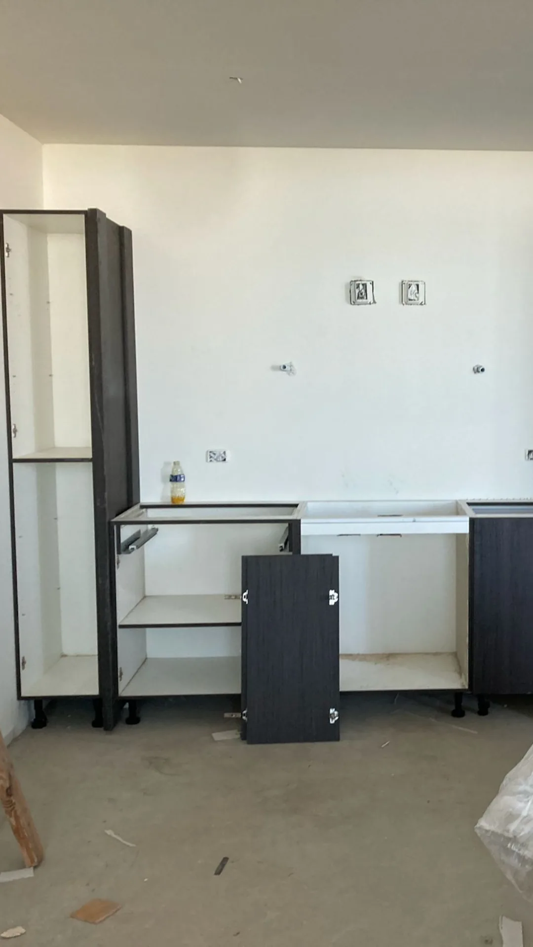 Cabinet installation in progress in an empty room