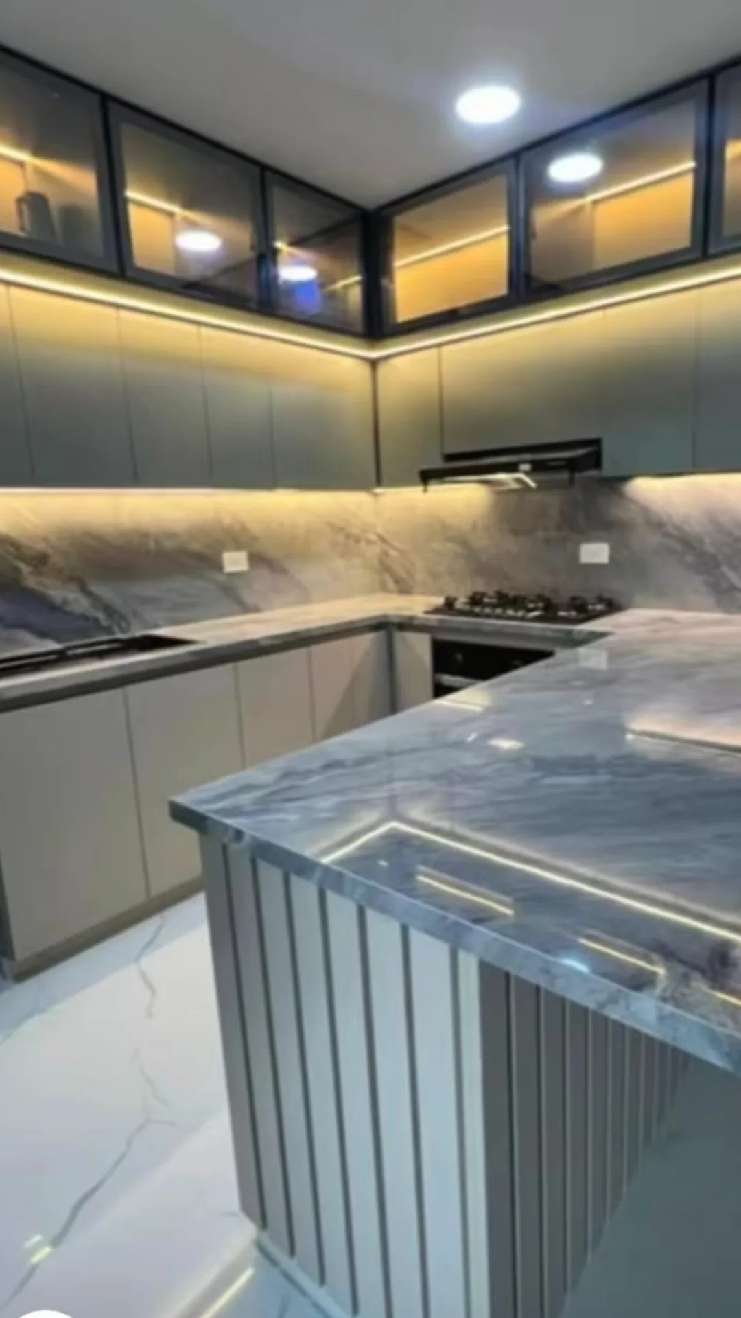 Modern kitchen with dark cabinets and under-cabinet LED lighting